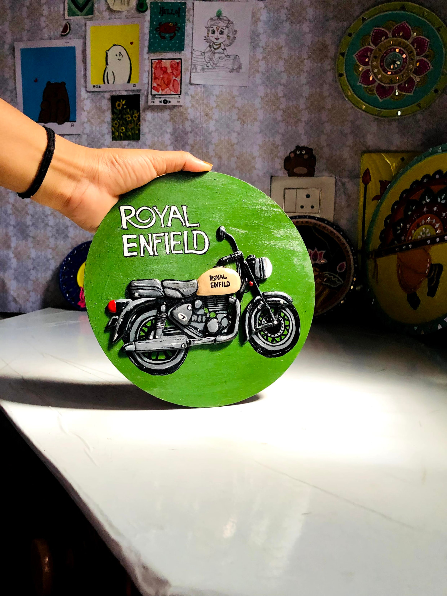 Custom Royal Enfield motorcycle Lippan artwork on a green circle