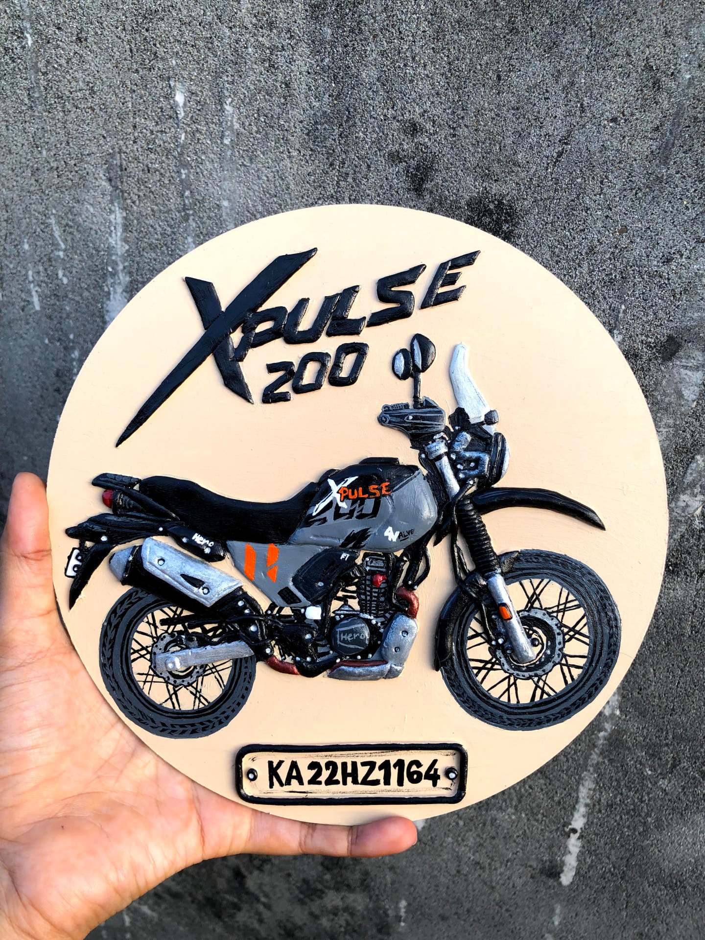 Close view of hand-painted raised motorcycle details on a Lippan artwork