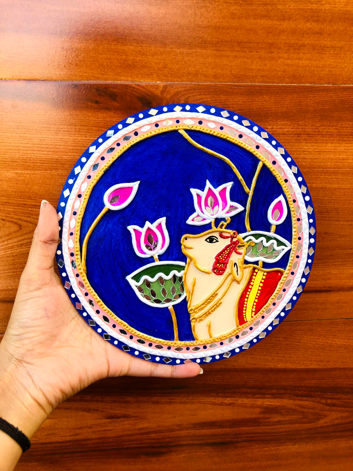 Hand-painted Krishna Lippan wall art with colorful geometric border
